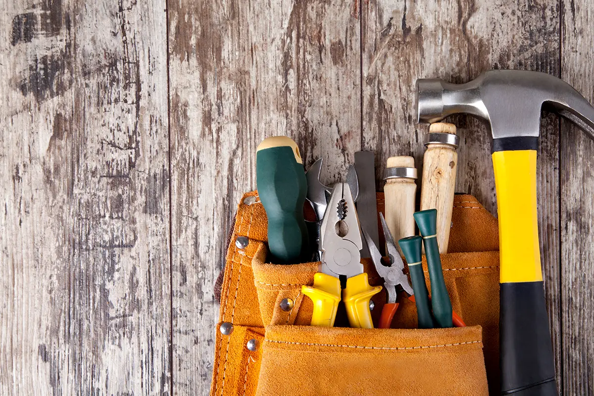 عکس استوک کمربند ابزار روی زمینه چوبی